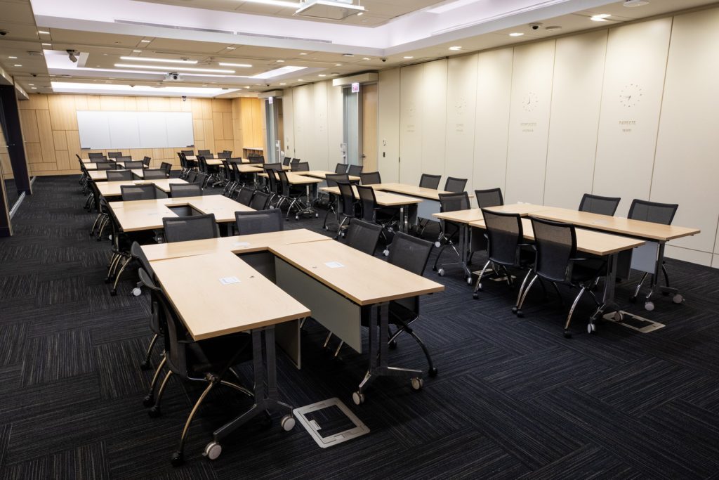Conference Room 1ABC at One Rotary Place. Photo of a large conference room with tables & chairs and a whiteboard.