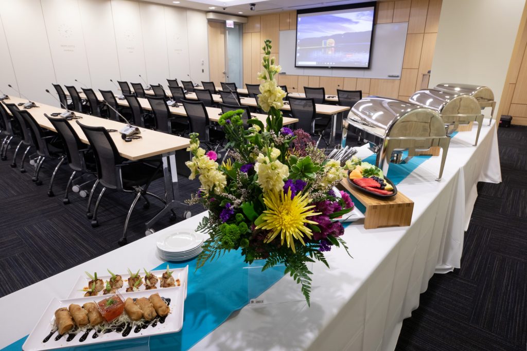 Catering Food at One Rotary Place. Photo of a deluxe spread of catered food for business conferences. Photo backdrop is a large conference room.