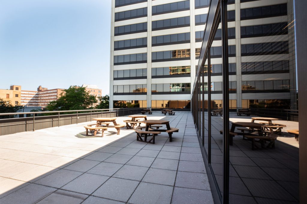 3rd Floor Patio at One Rotary Place. Photo of tables on a large outdoor balcony that can be rented for events and receptions.